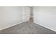 Minimalist bedroom featuring gray carpet, fresh paint, and base molding at 6003 W Harwood Ave, Orlando, FL 32835
