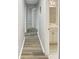 Long hallway boasting modern gray wood floors leading to the bathroom and bedroom at 6003 W Harwood Ave, Orlando, FL 32835