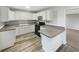 Bright kitchen with white cabinets, modern countertops, and new black appliances at 6003 W Harwood Ave, Orlando, FL 32835