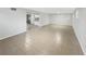 Spacious living area showcasing tiled floors and an open layout connected to the kitchen at 6003 W Harwood Ave, Orlando, FL 32835