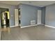 Open living space featuring modern flooring and a stacked washer and dryer at 613 20Th St, Orlando, FL 32805