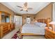 Large main bedroom with trey ceiling, carpet floors, dresser, and nightstands at 6743 Cherry Grove Cir, Orlando, FL 32809