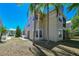 Back exterior of a well-maintained house featuring a screened patio and landscaped yard at 6936 Della Dr # 33, Orlando, FL 32819