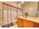 Bathroom featuring a vanity, toilet, mirror, and tub/shower combo with white shower curtain at 6936 Della Dr # 33, Orlando, FL 32819