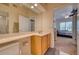 Light-filled bathroom with a vanity, toilet, and view towards the bedroom creates an open and inviting space at 6936 Della Dr # 33, Orlando, FL 32819