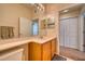 Bathroom with a vanity and a large mirror with access to the bedroom and closet at 6936 Della Dr # 33, Orlando, FL 32819