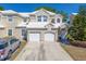 Charming townhouse featuring a two-car garage and a well-maintained lawn and landscape at 6936 Della Dr # 33, Orlando, FL 32819