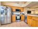 Well-equipped kitchen featuring stainless appliances, wooden cabinets, and an open layout for easy socializing at 6936 Della Dr # 33, Orlando, FL 32819