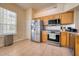 Functional kitchen featuring stainless steel appliances, tiled floor, and a pantry, ensuring convenience and style at 6936 Della Dr # 33, Orlando, FL 32819