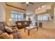 Comfortable living room with a brown sofa, coffee table, and abundant natural light at 6936 Della Dr # 33, Orlando, FL 32819