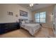 Main bedroom is furnished with a large bed, dresser, whiteboard, and ample natural light at 6936 Della Dr # 33, Orlando, FL 32819