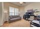 Home office with gray couch and large window letting in natural light at 6936 Della Dr # 33, Orlando, FL 32819