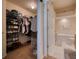 Spacious walk-in closet with shelving for shoes and hanging storage with access to the primary bathroom at 6936 Della Dr # 33, Orlando, FL 32819