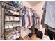 Walk-in closet showing shelving for shoes and hanging storage for clothing at 6936 Della Dr # 33, Orlando, FL 32819
