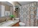 Well-lit bathroom featuring a decorative shower curtain, granite countertops, and a stylish vanity at 696 Seabrook Ct # 101, Altamonte Springs, FL 32714