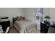 Cozy bedroom with a decorative comforter and black wood furnishings at 696 Seabrook Ct # 101, Altamonte Springs, FL 32714