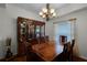 Formal dining room with elegant chandelier, hardwood floors, and a classic china cabinet at 696 Seabrook Ct # 101, Altamonte Springs, FL 32714