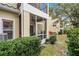 Exterior screened-in porch with ceiling fan and view of the green lawn at 696 Seabrook Ct # 101, Altamonte Springs, FL 32714