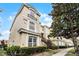 Three-story building exterior shows staircase, tiled roof, and beige stucco facade at 696 Seabrook Ct # 101, Altamonte Springs, FL 32714