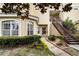 Building exterior features a staircase, well-maintained landscape, and covered entryway at 696 Seabrook Ct # 101, Altamonte Springs, FL 32714