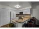 Kitchen with stainless appliances, granite countertops, white cabinets, and breakfast bar at 696 Seabrook Ct # 101, Altamonte Springs, FL 32714