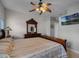 Well-lit main bedroom featuring dark wood furniture, ceiling fan and a wall-mounted television at 696 Seabrook Ct # 101, Altamonte Springs, FL 32714
