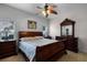 Comfortable main bedroom featuring a ceiling fan, tile floors, and elegant dark wood furniture at 696 Seabrook Ct # 101, Altamonte Springs, FL 32714