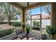 Relaxing screened patio with a table, chairs, and view of the lush backyard at 696 Seabrook Ct # 101, Altamonte Springs, FL 32714