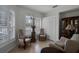 Bright sitting room with shuttered windows, comfortable seating, and a classic display cabinet at 696 Seabrook Ct # 101, Altamonte Springs, FL 32714