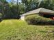 A well-manicured lawn extending from the side of the house, showcasing the spacious backyard at 736 Silverwood Dr, Lake Mary, FL 32746
