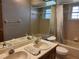Bathroom with a large mirror, dual sinks, and a shower/tub combo with tiled surround at 736 Silverwood Dr, Lake Mary, FL 32746