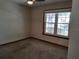Neutral bedroom with carpet flooring and a window offering views of the outdoors at 736 Silverwood Dr, Lake Mary, FL 32746