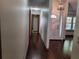 Hallway leads to a front door with glass pane, and a chandelier adding warmth to the entry at 736 Silverwood Dr, Lake Mary, FL 32746