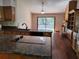 Open kitchen with granite countertops and pool view at 736 Silverwood Dr, Lake Mary, FL 32746