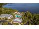 Aerial view of the community pool and amenities center on the shore of a lake at 806 Lucaya Loop, Davenport, FL 33897