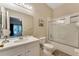 Bright bathroom featuring a vanity, toilet, and shower with sliding glass doors at 806 Lucaya Loop, Davenport, FL 33897