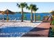 Community beach area featuring a sandy beach, lounge chairs, and water views at 806 Lucaya Loop, Davenport, FL 33897
