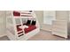 Cozy bedroom features a bunk bed with red bedding, and a dresser at 806 Lucaya Loop, Davenport, FL 33897