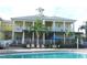 Inviting community pool area with ample seating and a charming building with balconies at 806 Lucaya Loop, Davenport, FL 33897