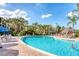 Beautiful community pool with lounge chairs and tropical landscaping, perfect for relaxing at 806 Lucaya Loop, Davenport, FL 33897
