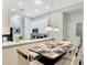 Cozy dining area with modern lighting and seating, adjacent to the well-equipped kitchen at 806 Lucaya Loop, Davenport, FL 33897
