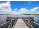 Picturesque lake view featuring a fishing pier and endless beautiful blue skies at 806 Lucaya Loop, Davenport, FL 33897