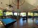 Spacious game room featuring a pool table and comfortable seating, perfect for entertaining guests at 806 Lucaya Loop, Davenport, FL 33897