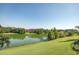 Expansive lake view with lush green surroundings and community buildings at 806 Lucaya Loop, Davenport, FL 33897
