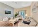 Comfortable living room featuring stylish furniture, neutral tones, and a sliding door to the balcony at 806 Lucaya Loop, Davenport, FL 33897