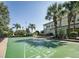 Well-maintained shuffleboard court surrounded by palm trees, perfect for outdoor recreation at 806 Lucaya Loop, Davenport, FL 33897
