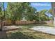 Large backyard with a well-maintained lawn, patio, fenced perimeter, a small playhouse and a concrete slab at 851 W 24Th Pl, Sanford, FL 32771
