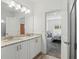 Bathroom featuring double sinks with granite countertops, and access to bedroom with sitting area at 851 W 24Th Pl, Sanford, FL 32771