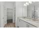Bathroom featuring double sinks with granite countertops, and access to the walk-in closet and shower at 851 W 24Th Pl, Sanford, FL 32771