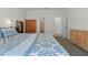 Bright bedroom with patterned bedding, natural wood furnishings, and neutral walls at 851 W 24Th Pl, Sanford, FL 32771